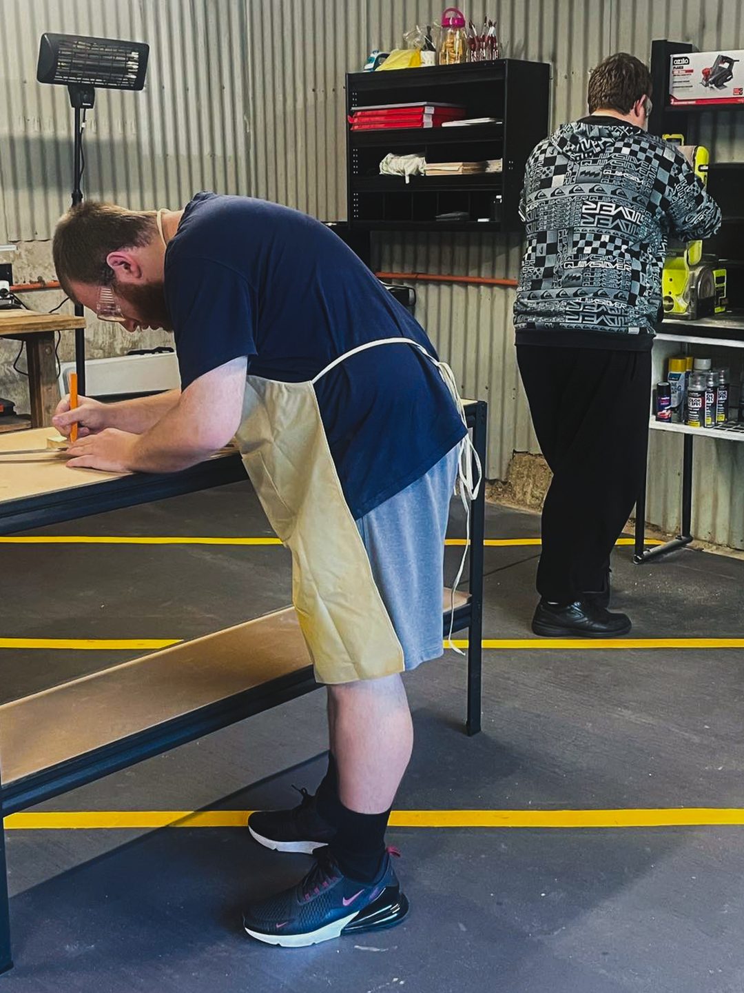 Marking out timber at the workshop bench