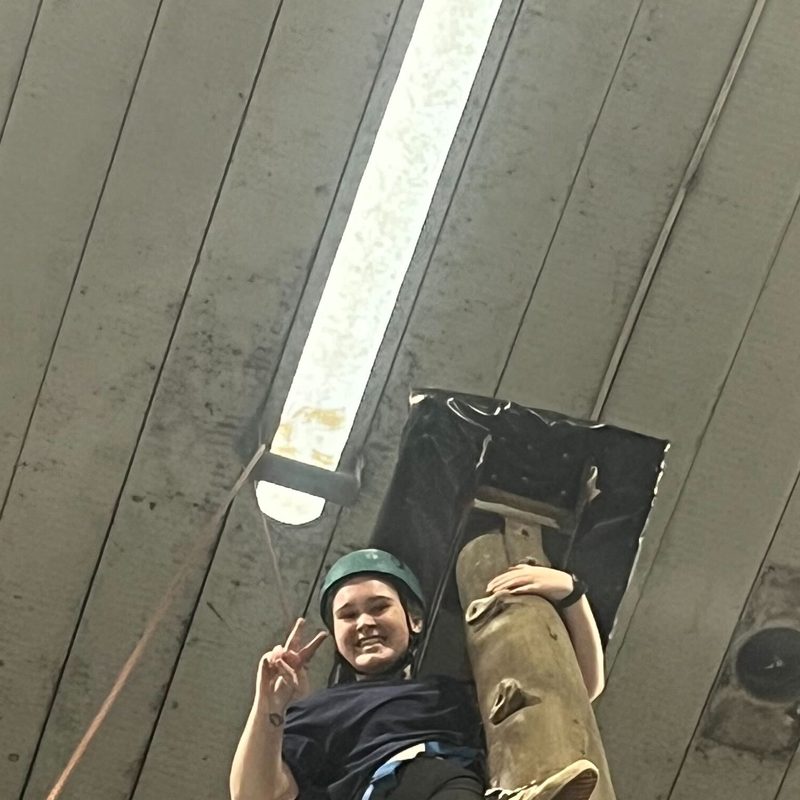 At the top of the climb, giving a peace sign
